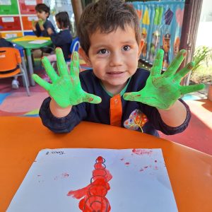 Manos de niños pintadas con colores vivos en Kids Tree Learning Club